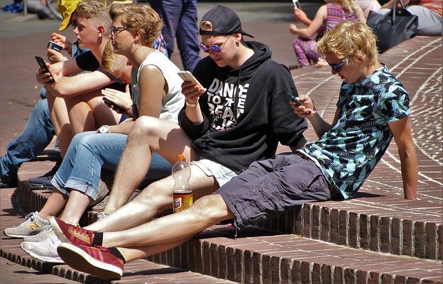 people using phone on street