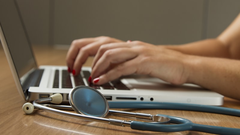 Doctor using hospital software dashboard on tablet
