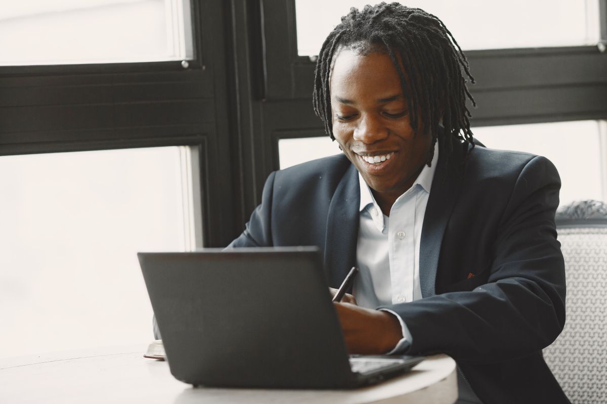 Digital marketing professional smiling while working on a laptop