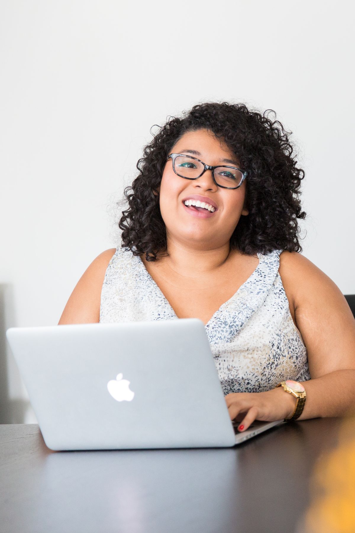 Digital marketing professional working confidently on a laptop at her desk