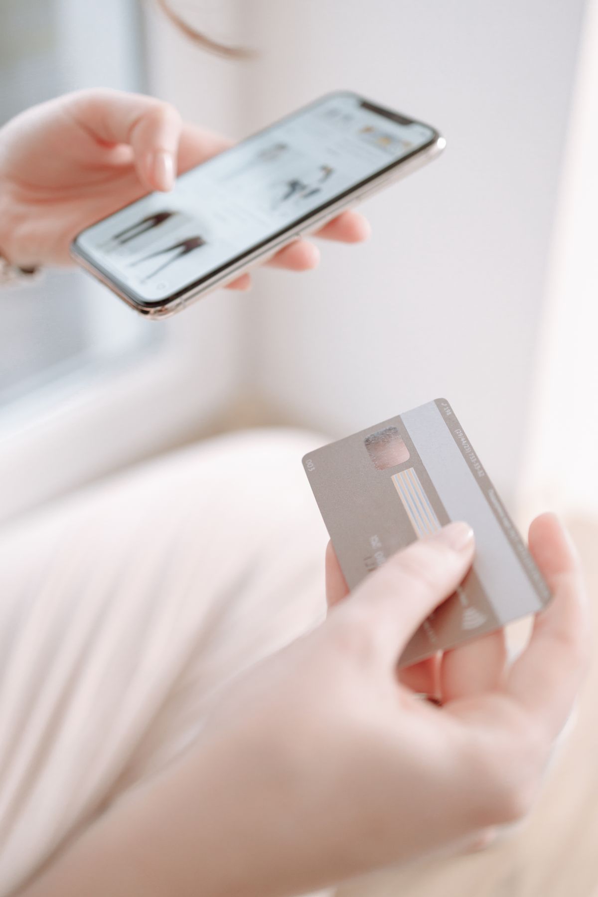 Hands holding a smartphone and credit card for online shopping payment