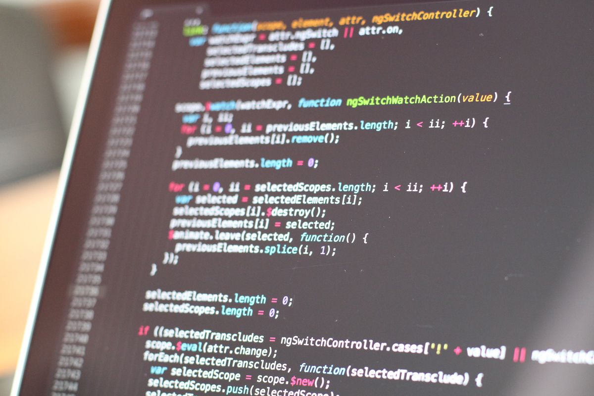 Colorful code on a laptop screen representing SEO keyword implementation