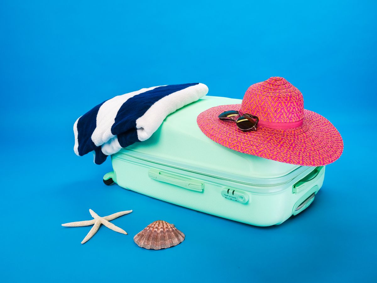 Beach vacation essentials including suitcase representing the travel and tourism industry