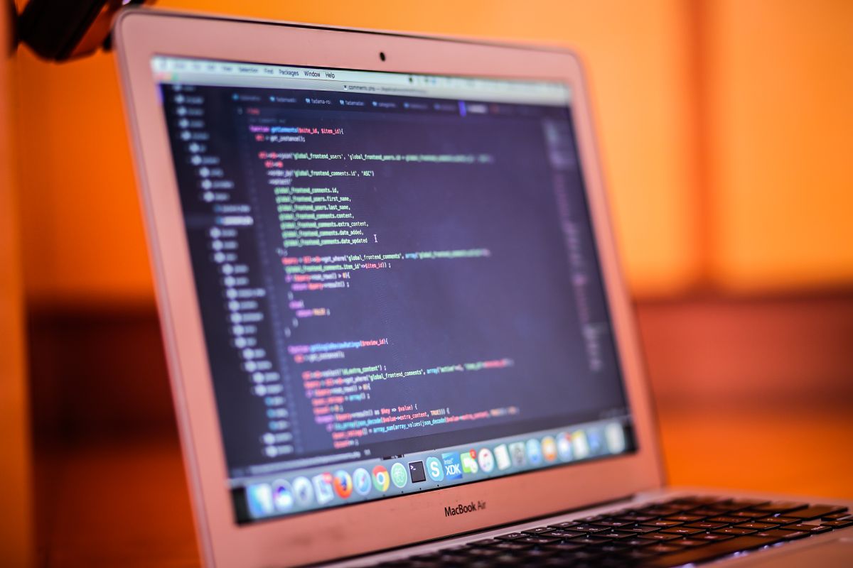 Laptop displaying website code representing web design and development work