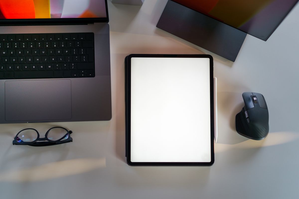 Laptop and tablet screen mockup on an office desk representing website design
